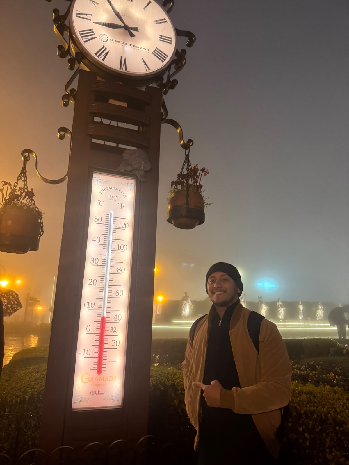 Agente de viagens Luiz Abreu, de Belém, ao lado do relógio-termômetro de Gramado, na serra gaúcha, em noite de neblina